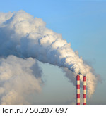 Pair of Fuming industrial tubes chimneys smoke heating station blue sky. Стоковое фото, фотограф Camptoloma / Фотобанк Лори