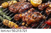 A BBQ grill with assorted meats and vegetables being cooked, sizzling and releasing appetizing aromas. Стоковое AI-изображение, AI-художник Данила Большаков / Фотобанк Лори