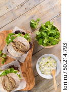 Healthy vegan burger with fresh vegetables and yogurt sauce on rustic kitchen counter top. Стоковое фото, агентство Ingram Publishing / Фотобанк Лори