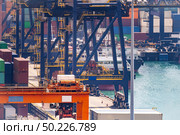 Working at Tshing yi Hong Kong Port for shipping and freight transportation and global business import and export background. Стоковое фото, агентство Ingram Publishing / Фотобанк Лори