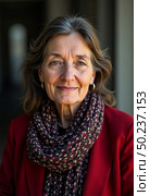 A woman stands confidently, her warm smile illuminated by sunlight. Dressed in a cozy red jacket and a patterned scarf, she exudes charm and approachability among historic architecture Generative AI. Стоковое AI-изображение, AI-художник Юлия Петровская / Фотобанк Лори