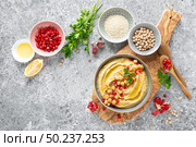 Chickpea hummus with tahini in a bowl. Healthy vegetarian appetizer. Middle Eastern cuisine. Стоковое фото, агентство Ingram Publishing / Фотобанк Лори