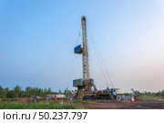 Drilling a well in an oil field. Mobile drilling rig and drilling equipment. Summer. Beautiful sky and nature. Стоковое фото, фотограф Владимир Ендовицкий / Фотобанк Лори