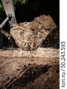 Excavator working with soil and water, during earthmoving works. Стоковое фото, агентство Ingram Publishing / Фотобанк Лори