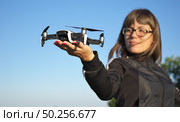 Drone landing on a woman hand palm. Element of design. Стоковое фото, агентство Ingram Publishing / Фотобанк Лори