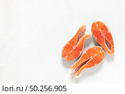Salmon. Fresh raw salmon fish steaks on white background, top view. Стоковое фото, агентство Ingram Publishing / Фотобанк Лори