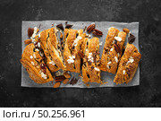 Homemade chocolate puff pastry braided strudel, pie with pecan nuts and almond, top view. Стоковое фото, агентство Ingram Publishing / Фотобанк Лори