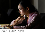 Young adult asian businesswoman working hard and late at night in her office with laptop computer. Using as hard working and working late concept. Стоковое фото, агентство Ingram Publishing / Фотобанк Лори