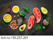 Omega-3 fats. Salmon fish and vegetarian sources of unsaturated fatty acids. Healthy food concept for good health. Top view. Стоковое фото, агентство Ingram Publishing / Фотобанк Лори