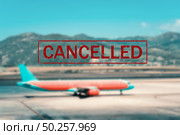 Airplane and flight cancellation. Canceled flights in Europe, Asia and USA airports. Travel cancelled. Pandemic of coronavirus. Background of passenger aircraft on runway at sunset and text. Covid-19. Стоковое фото, агентство Ingram Publishing / Фотобанк Лори