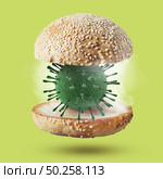 Flying hamburger bun with bacteria model of Coronavirus on a ligh green background, copy space. Outbreak of Coronavirus, Covid-19 or pandemic concept.. Burger bun with 3D model of Coronavirus molecule. Стоковое фото, агентство Ingram Publishing / Фотобанк Лори