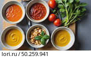 A food stylist's workspace with bowls of vibrant sauces. bright green herb pesto, deep red harissa, golden turmeric aioli arranged on beautiful modern kitchen. Стоковое AI-видео, аниматор Sergey Grishin / Фотобанк Лори