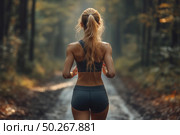 A young woman in sportswear runs along a forest path illuminated by the soft diffused light of early morning or sunset. The view from the back highlights her fit figure, strength and determination. The atmosphere is calm, unity with nature and inner concentration. The background is blurred trees and an illuminated path, creating a sense of depth and coziness. The image is perfect for the theme of a healthy lifestyle, fitness, morning habits, outdoor activities and personal motivation. Стоковое AI-изображение, AI-художник Анна Кривицкая / Фотобанк Лори