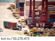 Working at Tsing yi Hong Kong Port for shipping and freight transportation with truck and boat for global business import and export background. Стоковое фото, агентство Ingram Publishing / Фотобанк Лори