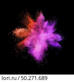 Creative chaotic powder explosion or burst in red and purple colors on a black background with copy space.. Red purple colored powder splash on a black background. Стоковое фото, агентство Ingram Publishing / Фотобанк Лори