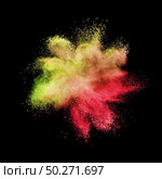 Creative chaotic powder explosion or splash in yellow and red colors on a black background with copy space.. Chaotic burst in yellow red colors on a black background. Стоковое фото, агентство Ingram Publishing / Фотобанк Лори