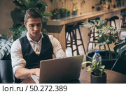 Young unemployed man is looking news for a job in the laptop. Стоковое фото, агентство Ingram Publishing / Фотобанк Лори