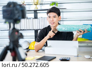 Young male vlogger live vlog video for selling online. online marketing concept. Стоковое фото, агентство Ingram Publishing / Фотобанк Лори