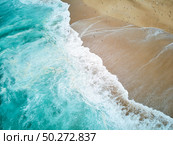 North Beach in Nazare Portugal with foaming waves and flying seagulls. Стоковое фото, агентство Ingram Publishing / Фотобанк Лори