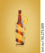 Creative spiral beer’s splash around brown bottle with water droplets on a light sand yellow colored backgound, copy space. Refreshing alcohol drinks.. Beer bottle with water drops and spiral splash around bottle. Стоковое фото, агентство Ingram Publishing / Фотобанк Лори