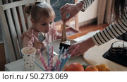 Children Eating Birthday Cake Slice on a Birthday Party at Home. Siblings, girls and a boy together celebrating a party, eating cake sitting at festive table. Little Kid Celebration. Surprise. Low key. Стоковое видео, видеограф Марина Демидюк / Фотобанк Лори