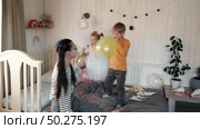 Fun Kids Celebration with Colorful Balloons, Party Horn Blowers and Festive Hats. Joyful Siblings Children Playful Little Girls and a Boy Dancing, Jumping, Playing among Golden Decorations. Party Time. Стоковое видео, видеограф Марина Демидюк / Фотобанк Лори