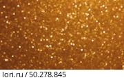 An abstract gold background with sparkle lights and bokeh. Useful as Christmas background or greeting card. Gold blurred light. Стоковое видео, видеограф Марина Демидюк / Фотобанк Лори