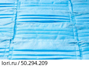 Creative background from medical antibacterial protective blue face masks. Concept of prevention from respiratory sickness and viruses.. Horizontal background from protective medical masks. Стоковое фото, агентство Ingram Publishing / Фотобанк Лори