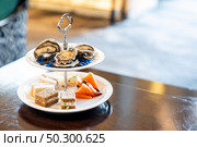 Welcome cocktail Canapes dish, Fresh Oyster and smoked salmon seafood dish. Appetizer dish before groumet brunch buffet international cuisine. Стоковое фото, агентство Ingram Publishing / Фотобанк Лори