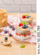 Chia pudding with oat and berries in a glass jar on rustic background. Стоковое фото, агентство Ingram Publishing / Фотобанк Лори