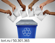 Wasted vote and voting fraud concept as diverse hands casting ballots at a polling station shaped as a recycling trash bin as a rigged election throwing votes in the garbage with 3D illustration elements. Стоковое фото, агентство Ingram Publishing / Фотобанк Лори