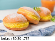 Bolas de Berlim, or "Berlin Balls". Portuguese fried dough with sugar, Filled with sweet egg cream. Стоковое фото, агентство Ingram Publishing / Фотобанк Лори