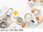 Baking homemade bread on white kitchen worktop with ingredients for cooking, culinary background, copy space, overhead view. Стоковое фото, агентство Ingram Publishing / Фотобанк Лори