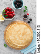 Thin crepes with fresh berries and lemon zest. Pancakes with raspberry and blackberry. Стоковое фото, агентство Ingram Publishing / Фотобанк Лори