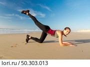 Shoot of a beautiful woman exercising herself in the beach. Стоковое фото, агентство Ingram Publishing / Фотобанк Лори