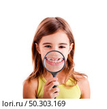 Beautiful girl showing teethes through a magnifying glass. Стоковое фото, агентство Ingram Publishing / Фотобанк Лори