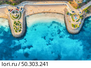 Aerial view of beautiful sandy beach, clear blue sea, promenade, swimming people in clear water, green trees at sunset in summer. Top view of seafront. Tropical landscape. View from drone of sea shore. Стоковое фото, агентство Ingram Publishing / Фотобанк Лори