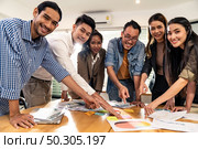 Interracial asian business team brainstorming idea talk and discuss at office meeting room after reopen due to coronavirus COVID-19 city lockdown. Business startup meeting and brainstorm concept. Стоковое фото, агентство Ingram Publishing / Фотобанк Лори