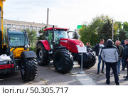 Универсальный колёсный трактор McCormick G165 Max II для сельского хозяйства, на выставке. Волгоград, Экспоцентр, Россия. Редакционное фото, фотограф Андрей Цыганков / Фотобанк Лори