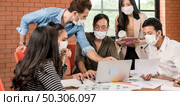 Panoramic group of asian caucasian business team meeting and brainstorm in meeting room after office reopen, they wear protective face mask as new normal practice to prevent coronavirus infection. Стоковое фото, агентство Ingram Publishing / Фотобанк Лори