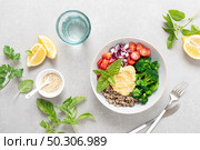 Vegetarian Buddha bowl with quinoa, vegetables and hummus, healthy food concept. Стоковое фото, агентство Ingram Publishing / Фотобанк Лори