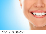 A woman is smiling while being at the dentist. Стоковое фото, агентство Ingram Publishing / Фотобанк Лори