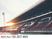 Stadium background with a green grass pitch in the daytime. Стоковое фото, агентство Ingram Publishing / Фотобанк Лори