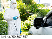 Car cleaning using chemical alcohol spray to disinfect and decontaminate coronavirus covid-19 by specialist cleaner wear personal protective equipment PPE. New normal Hygiene concept. Стоковое фото, агентство Ingram Publishing / Фотобанк Лори