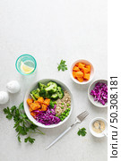 Vegetarian quinoa and broccoli lunch Buddha bowl with baked butternut squash or pumpkin, green peas and red cabbage, top down view. Стоковое фото, агентство Ingram Publishing / Фотобанк Лори