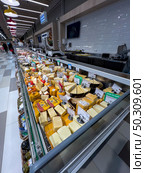 Refrigerator with cheese products from the supermarket "Spar" close-up. Russia. Moscow. 22.06.25. Редакционное фото, фотограф Ярославский Максим / Фотобанк Лори