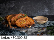 Traditional Christmas Rabanadas with lemon zest, raisins, pine nuts and cinnamon. Spanish Torrijas or french toasts close up on the countertop. Стоковое фото, агентство Ingram Publishing / Фотобанк Лори