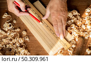 Carpenter working with small saw making sawdust. Стоковое фото, агентство Ingram Publishing / Фотобанк Лори