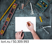 The set of construction tools on wooden background. The set of construction tools on wooden table. Стоковое фото, агентство Ingram Publishing / Фотобанк Лори