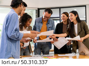 Interracial asian business team brainstorming idea talk and discuss at office meeting room after reopen due to coronavirus COVID-19 city lockdown. Business startup meeting and brainstorm concept. Стоковое фото, агентство Ingram Publishing / Фотобанк Лори